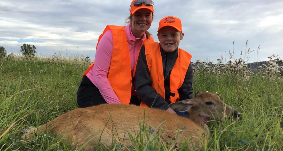 A mother and her son with a deer harvested through the Wood River Deer Hunt program 