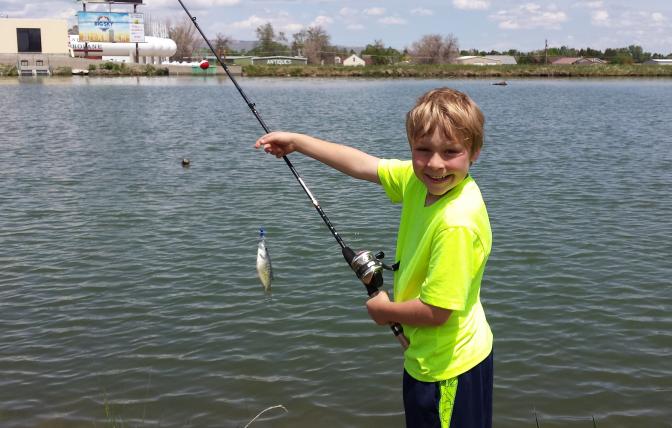 A young person shows off a fish caught a Beck Lake in Cody. 