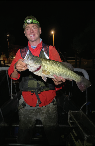 Colton Webb, Wyoming Game and Fish Department statewide aquatic assessment crew fisheries biologist holds a good-sized Wyoming largemouth bass from Sloans Lake in Cheyenne to evaluate the bass population.
