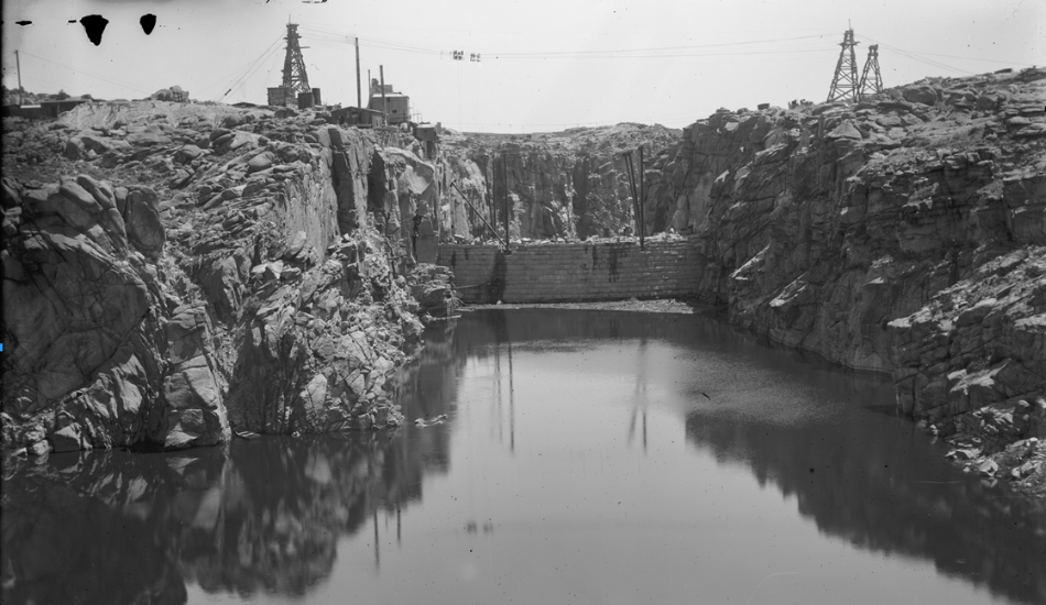 A black and white historic photo of Pathfinder Dam after its construction was completed in 1909