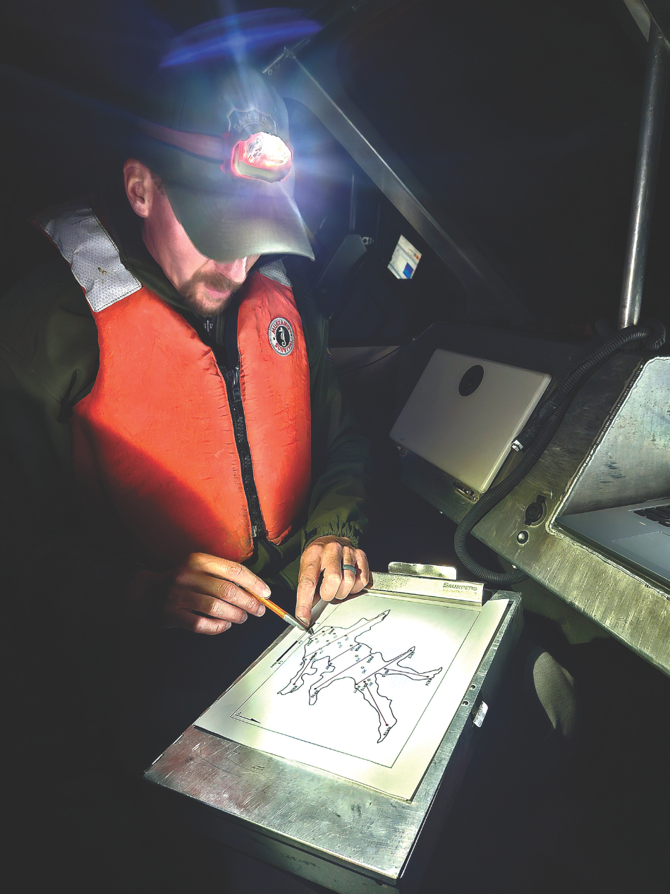 A Game and Fish biologist references a map of Rob Roy Reservoir to check the locations of each hydroacoustic transect that will be sampled.