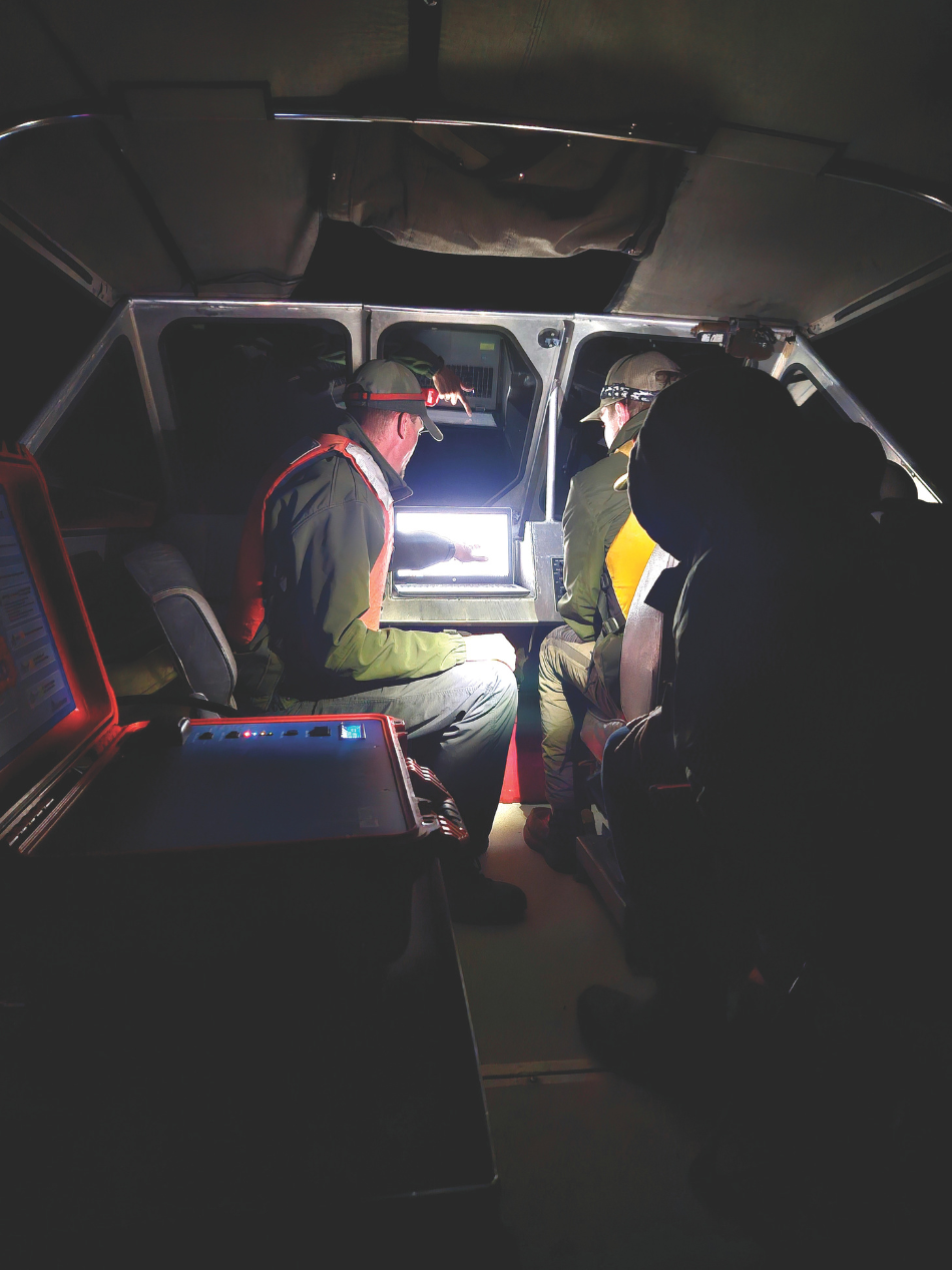 Biologists monitor the hydroacoustic output for recorded fish as they follow predetermined sampling paths across the reservoir