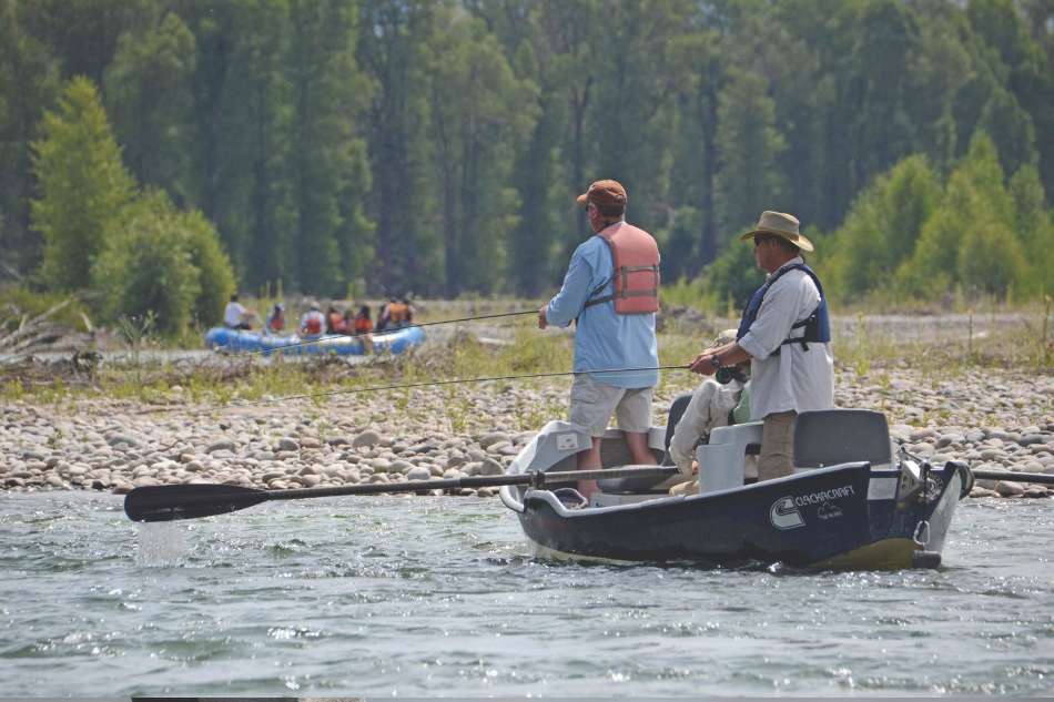 Snake River Anglers 3 male anglers fishing the Snake River from a drift boat.