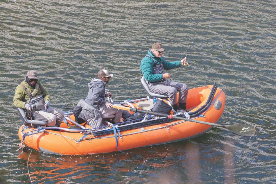 Fishing from a raft Three male anglers fish from an orange raft on the East Fork Wind River Drainaige.