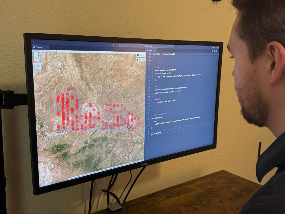 Garrett Catlin, reviews data collected by the J* during a pronghorn line transect survey, a method used to estimate pronghorn abundance.