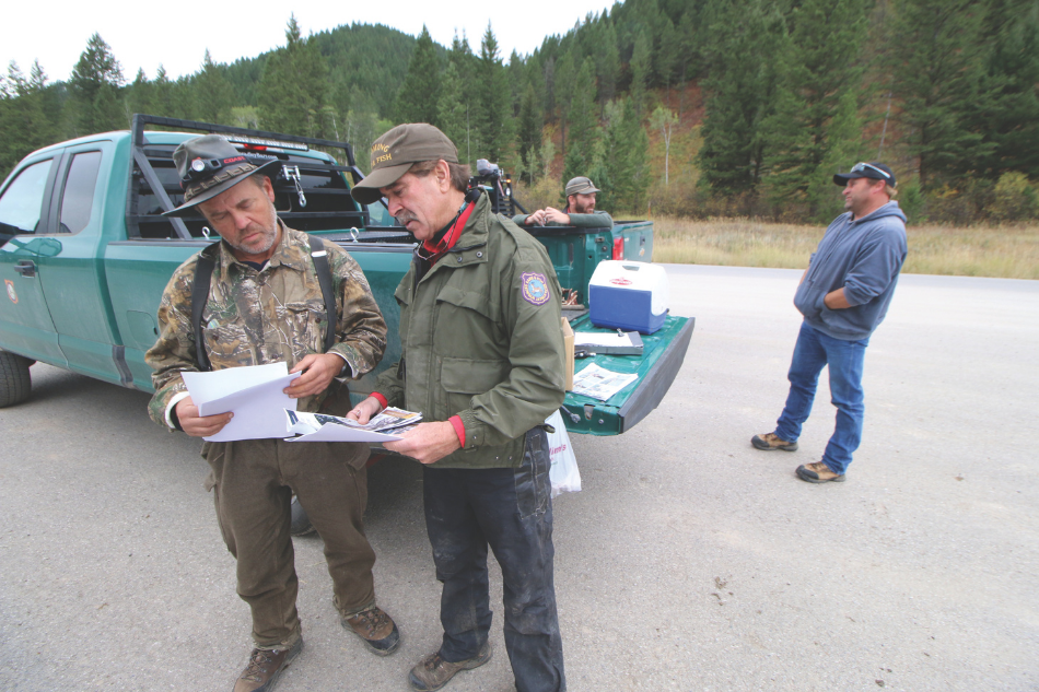 Gary Fralick, wildlife biologist for the Wyoming Game and Fish Department, speaks with a hunter at a hunter check station near Alpine.