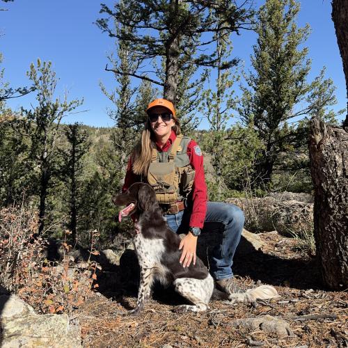 Game warden Elise Calhoun with her bird dog