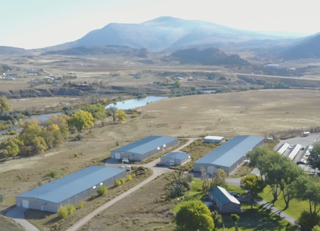 An aerial photo of the grounds at Dan Speas Fish Hatchery in Casper with mountains in the background.