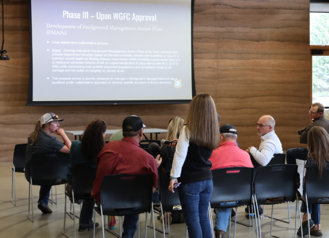 Members of the public gather at a public meeting for a presentation of the Wyoming Game and Fish Department's Draft Elk Feedgrounds Management Plan