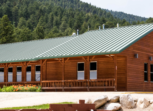 The exterior of the hatchery building with mountains in the background at Story Fish Hatchery.