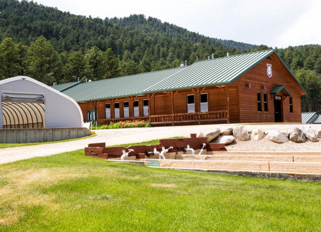 The outside of buildings at Story Fish Hatchery, nestled at the base of mountains