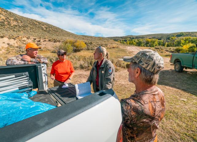 A game warden checks a license 