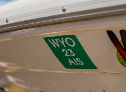 A Wyoming Aquatic Invasive Species (AIS) decal affixed to the side of a watercraft