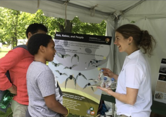 A National Parks Employee educates two members of the public about bats, rabies and people.