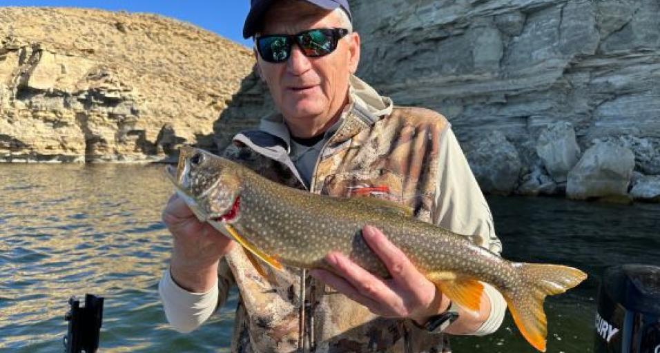 Game and Fish Commissioner Ken Roberts holds a lake trout 