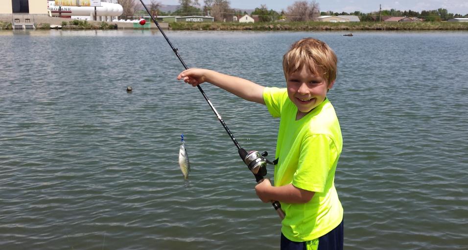 A young person shows off a fish caught a Beck Lake in Cody. 