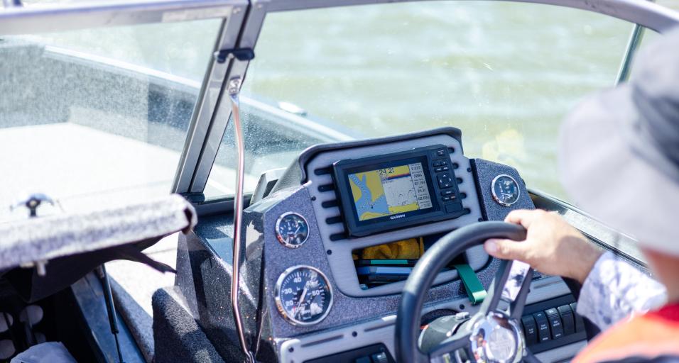 A person driving a boat. 