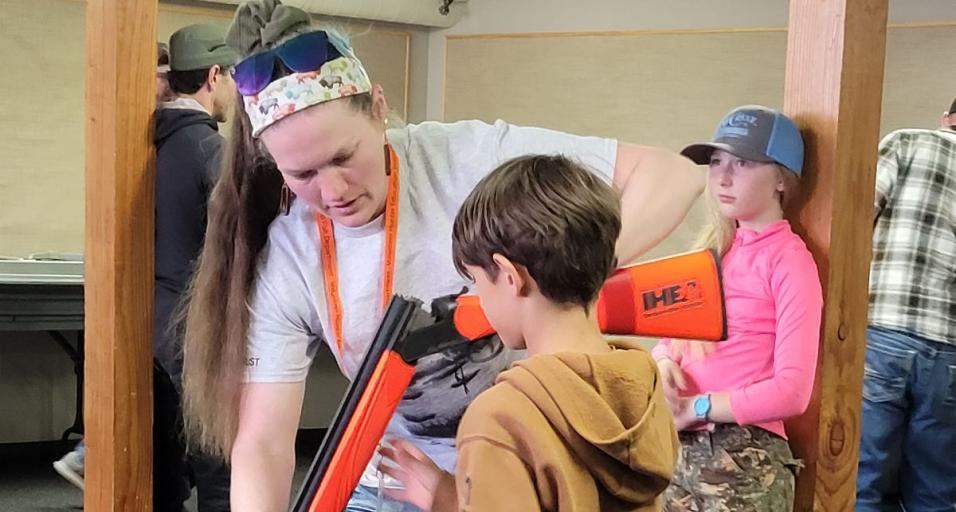 Hunter education instructor teaches a student