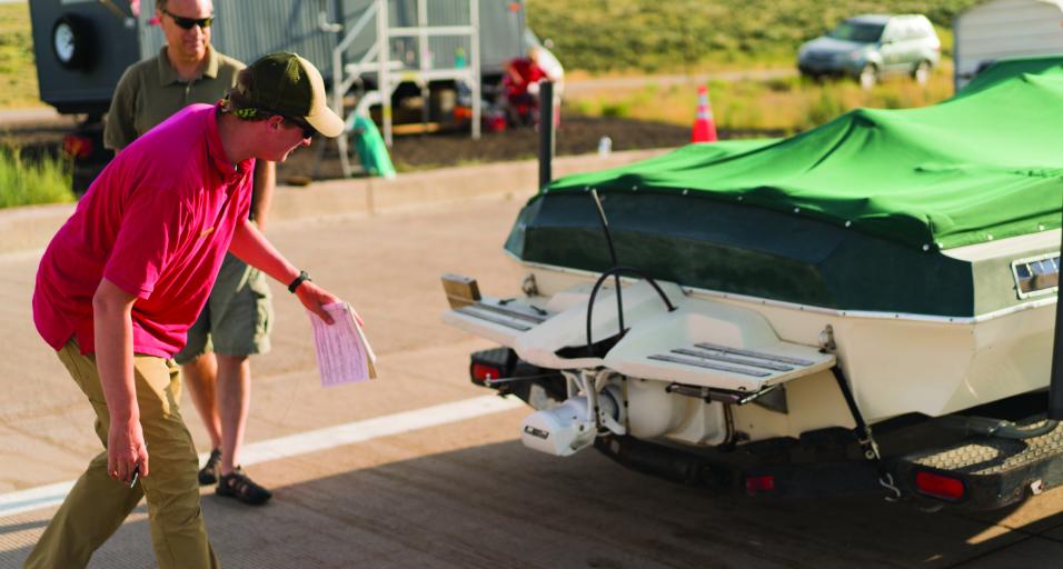 A Wyoming Game and Fish aquatic invasive species inspector checks a watercraft to ensure it is safe for Wyoming waterways.