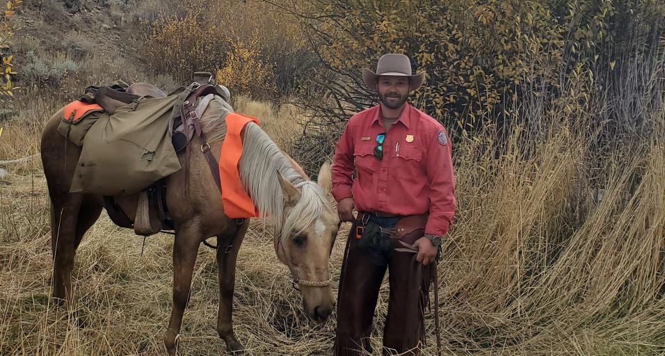 Levi Wood, South Cody Game Warden leading a pack horse 