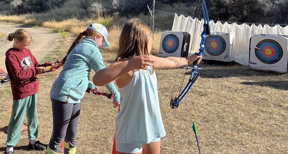 Participants of the 2024 Medicine Lodge Kids Outdoor Day practice archery 