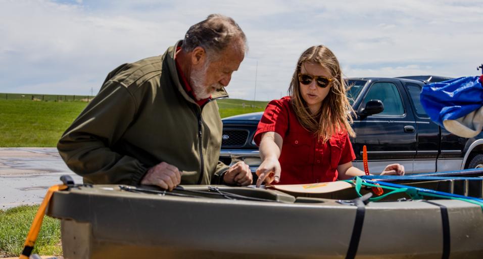 Game and Fish personnel check watercraft for AIS at a check station.