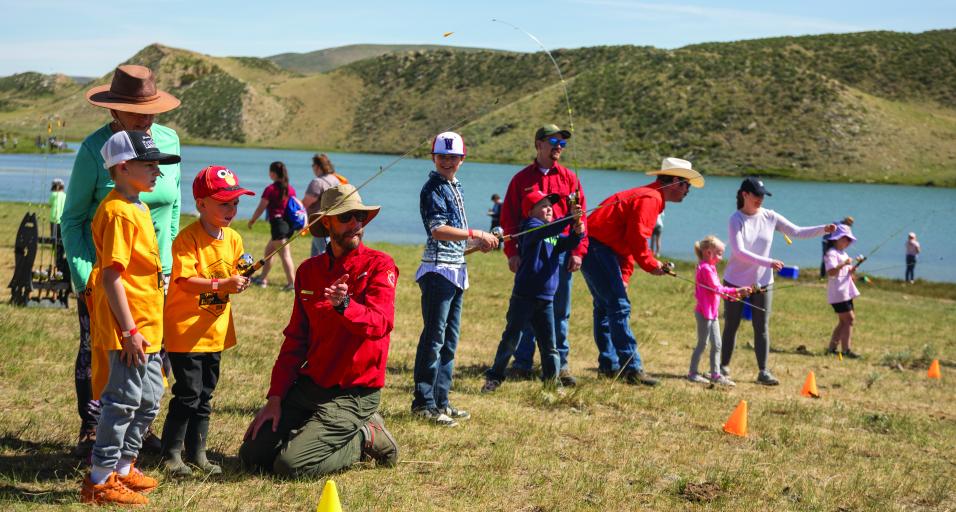 Wyoming Game and Fish Department fisheries staff help kids hone their fishing skills at the Maury Brown kids fishing day outside of Cheyenne in June 2024.