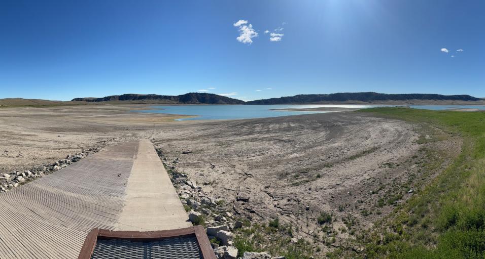 A photo of Upper Sunshine Reservoir with low water levels and a boat ramp completely out of the water. 