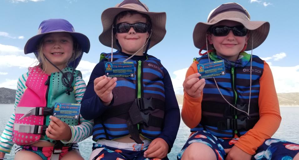 kids on a boat in lifejackets