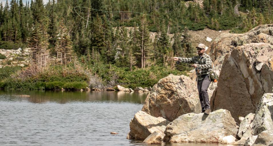 Angler fishing in the snowy mountain range
