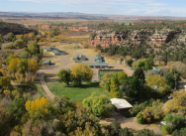 An aerial photo of Wigwam Fish Rearing Station in Ten Sleep Canyon with rocky bluffs and trees in the background.