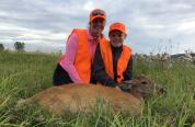 A mother and her son with a deer harvested through the Wood River Deer Hunt program 