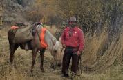 Levi Wood, South Cody Game Warden leading a pack horse 
