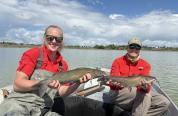Fisheries Technicians Caroline Varie and Vaughn Reschenberg with Kinnear Lake channel catfish, June 2025
