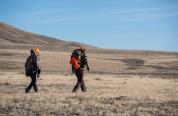 Hunters walking across landscape in Wyoming. Hunters walking across landscape in Wyoming.