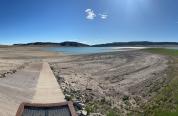 A photo of Upper Sunshine Reservoir with low water levels and a boat ramp completely out of the water. 