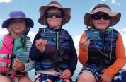 kids on a boat in lifejackets