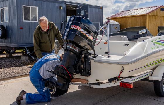 AIS check station employee checks watercraft.