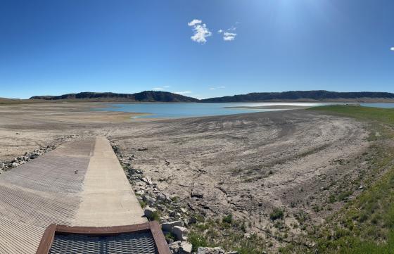 A photo of Upper Sunshine Reservoir with low water levels and a boat ramp completely out of the water. 