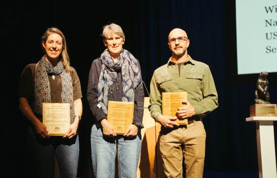 Aly Courtemanch (left), Sarah Dewey (center), and Eric Cole (right) accept the Craighead Conservation Award at the 2026 Northern Rockies Conservation Symposium (courtesy of Northern Rockies Conservation Cooperative).