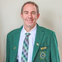 Wyoming Game and Fish Commissioner Rusty Bell in a green sport coat with the Game and Fish Shield embroidered on it