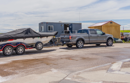 Pickup truck with a motorized watercraft stopped at an AIS check station
