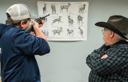 Student learning how to safely handle a firearm, marksmanship 