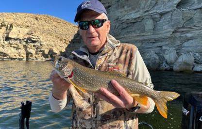 Game and Fish Commissioner Ken Roberts holds a lake trout 
