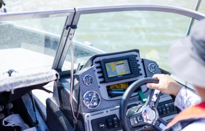 A person driving a boat. 
