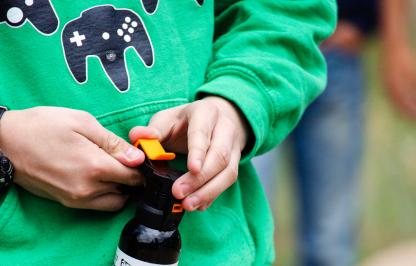 Young man holding bear spray