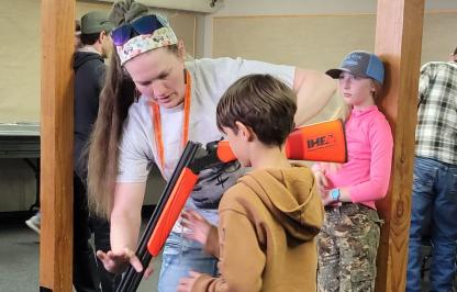 Hunter education instructor teaches a student