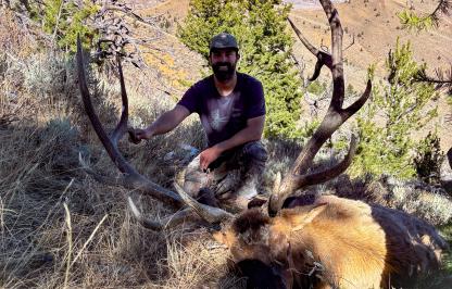 2025 Super Tag trifecta winner Nathan Miller poses with a bull elk he harvested in a previous hunting season.