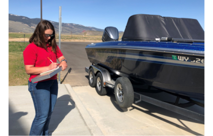 Emily Youse inspecting a boat for aquatic invasive species 