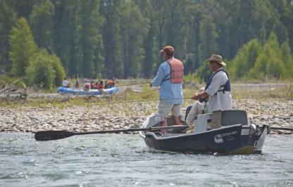 Snake River Anglers 3 male anglers fishing the Snake River from a drift boat.